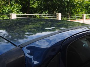A car with a dent in its bodywork